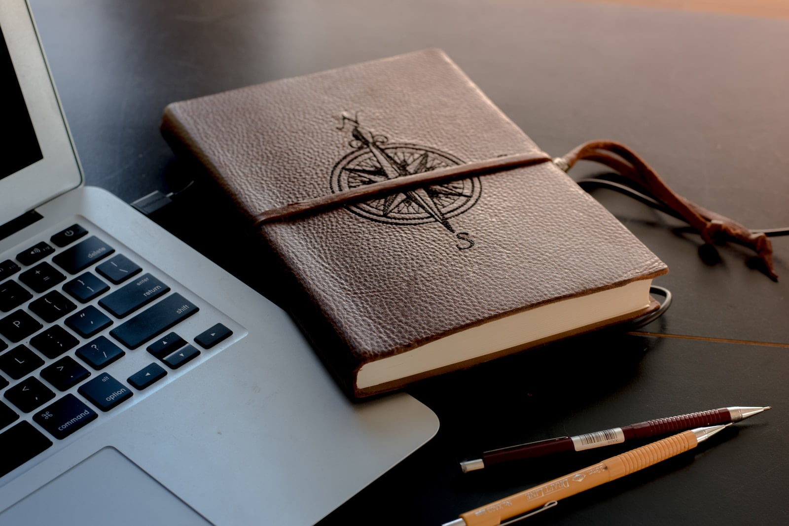 Photo by Colton Sturgeon brown book beside MacBook